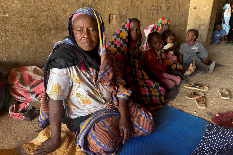 Displaced women from South Kordofan sit on the ground in El Obeid, North Kordofan State, Sudan, on January 15, 2026.
