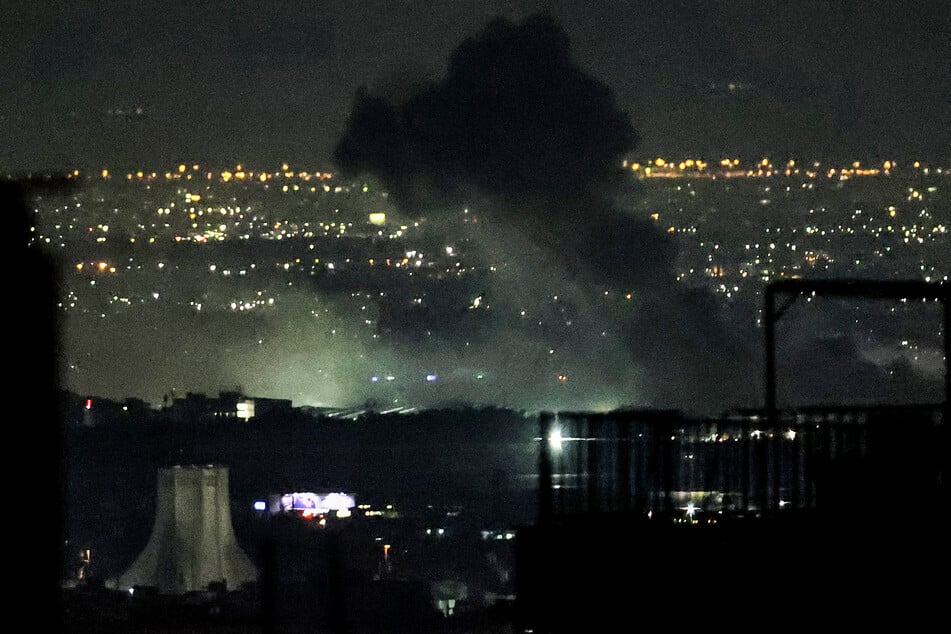 Smoke plumes billow from the site of airstrikes near Azadi Tower in western Tehran, Iran, on March 10, 2026.