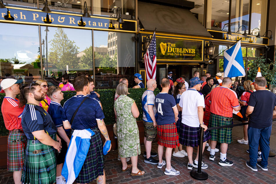 Scotland fans wear jerseys as they wait outside The Dubliner bar before a FIFA World Cup watch party on Saturday in Boston.