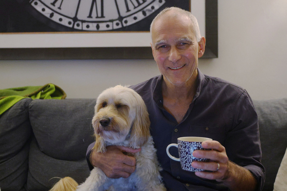 Moungi Bawendi, a professor at the Massachusetts Institute of Technology, sits with his dog Phoebe at home after winning the 2023 Nobel Prize in Chemistry.