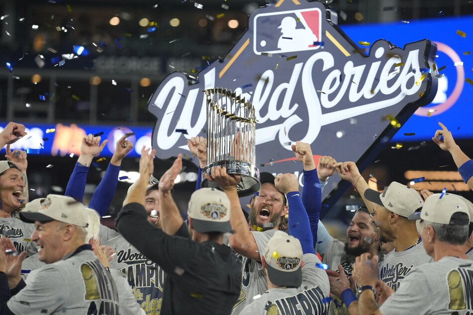 The Los Angeles Dodgers celebrate with the Commissioner's Trophy on the podium after defeating the Toronto Blue Jays in the 2025 MLB World Series at Rogers Centre.