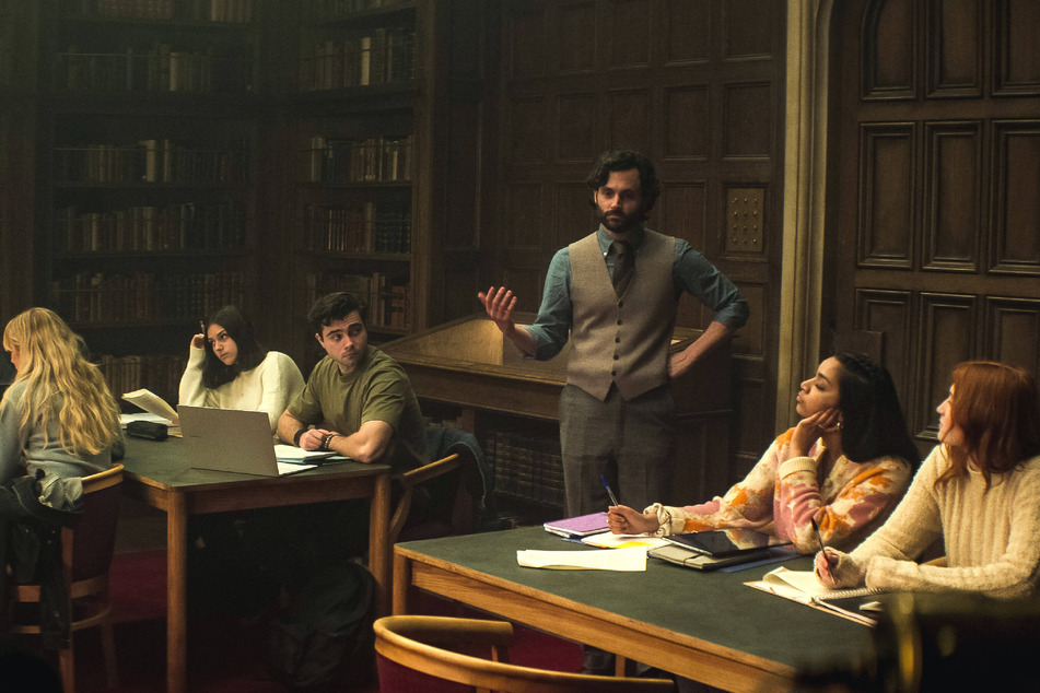 Penn Badgley's Joe Goldberg (c) is back to his old obsessive habits in the fourth season of Netflix's, You.