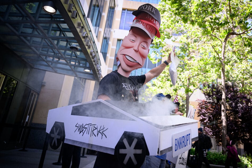 Protesters chant outside the federal courthouse during the Elon Musk vs. OpenAI trial in Oakland, California, on May 12, 2026.