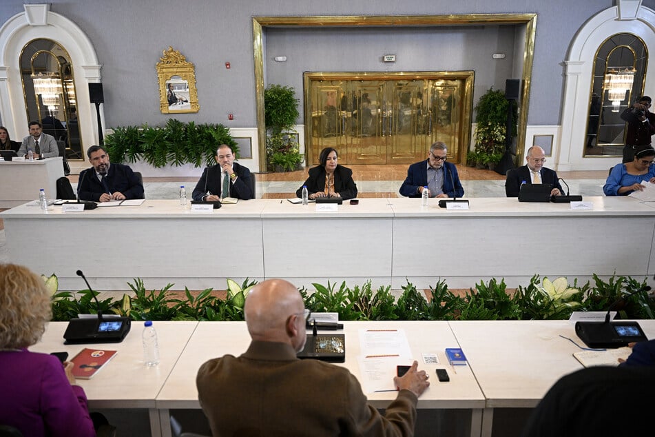 Opposition delegation head Dinorah Figuera (c.) attends the third round of political dialogue with the interim government at the Melia hotel in Caracas, Venezuela, on October 14, 2026.