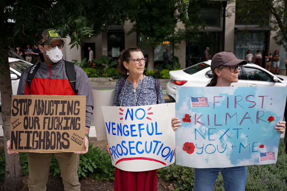 Supporters hold signs as they gather for Kilmar Abrego Garcia's arraignment and detention hearing in Nashville, Tennessee, on June 13, 2025.