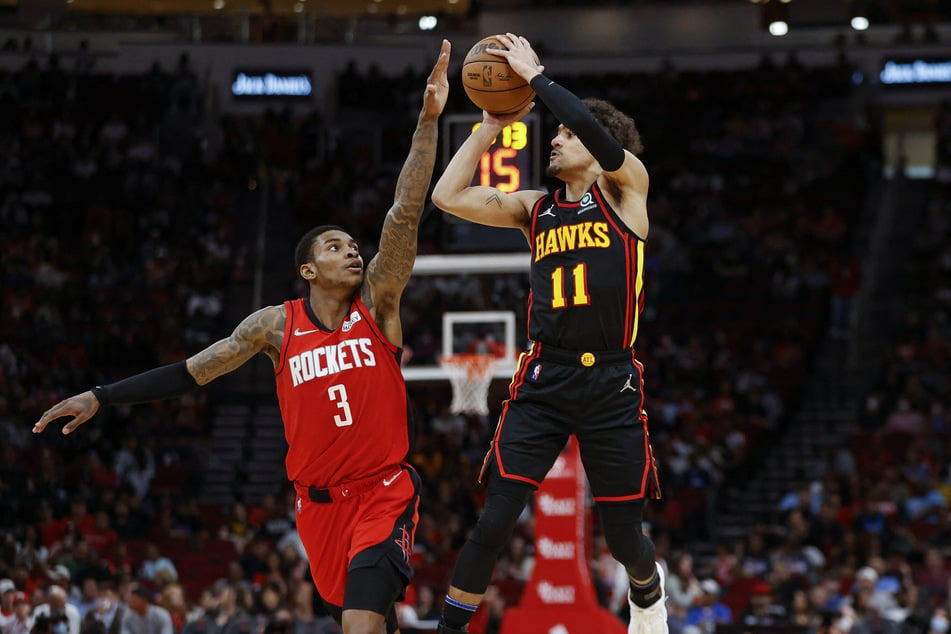 Trae Young (r.) goes up to shoot during the Hawks' regular season finale win over the Rockets.
