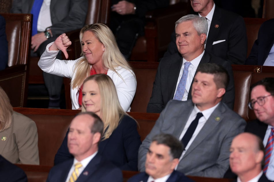 Marjorie Taylor Greene (l.) threatened Johnson with a motion to vacate if he doesn't abandon the deal struck with Democrats on government funding.