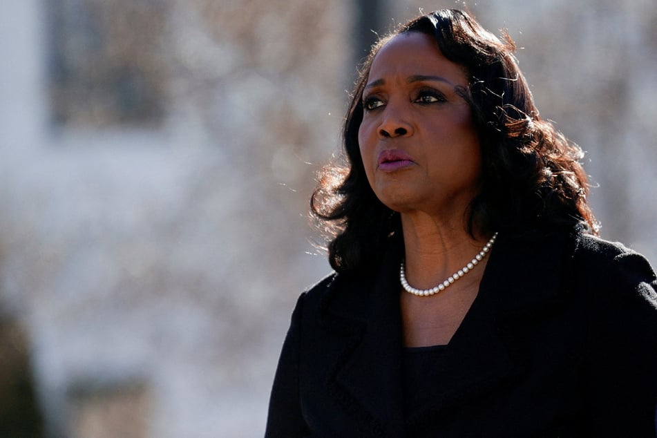 Federal Reserve Governor Lisa Cook walks outside the Supreme Court, as justices consider President Donald Trump's effort to fire her, on January 21, 2026. Her lawyer has said she is not available for a November 5 hearing on the administration's accusations against her.