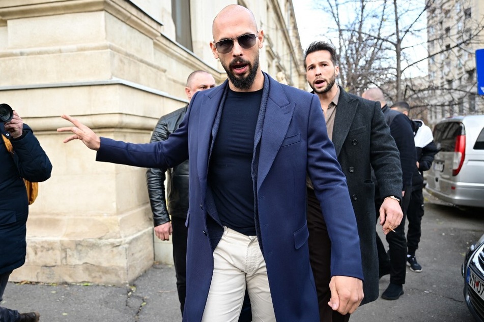 Andrew Tate walks from Bucharest's Court of Appeal after a hearing on his demand to be allowed to leave Romania to visit his mother, on December 22, 2023.