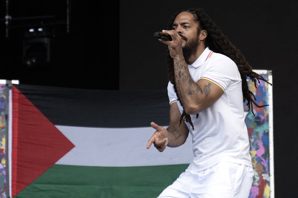 To the backdrop of a Palestinian flag, Bobby Vylan of British duo Bob Vylan performs on the West Holts Stage on the fourth day of the UK's Glastonbury festival on June 28, 2025.