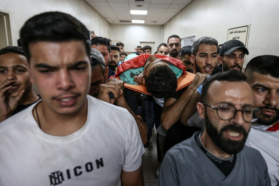 Mourners carry the body of one of two Palestinian teens killed at Ramallah government hospital, after an Israeli settler attack followed by an Israeli army raid in Al-Mughayyir in the occupied West Bank on September 2, 2026.
