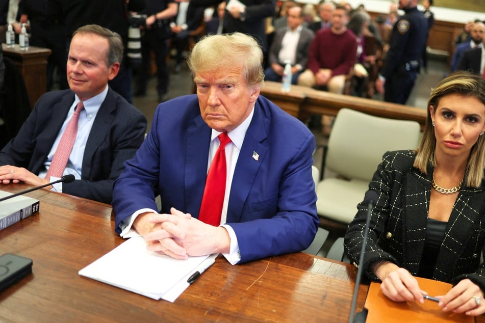 On Wednesday, Donald Trump (c.) and his legal team filed a request for a judge to delay penalties attached to damages he owes in his New York fraud trial.