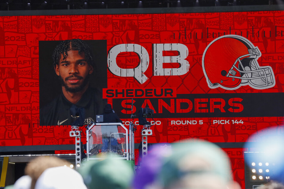 A graphic announcing Colorado quarterback Shedeur Sanders’ selection by the Cleveland Browns with the 144th overall pick is pictured in the Draft Theater during the third day of the 2025 NFL Draft at Lambeau Field.