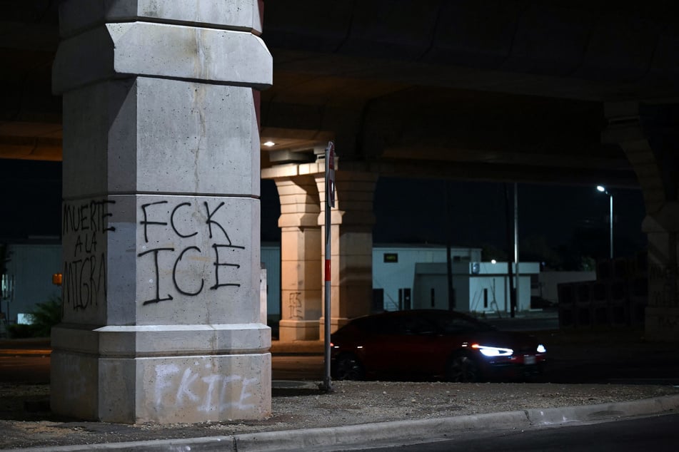 Freshly painted graffiti is seen at the site where a Venezuelan national was shot and wounded by ICE in Austin, Texas, on September 20, 2026.