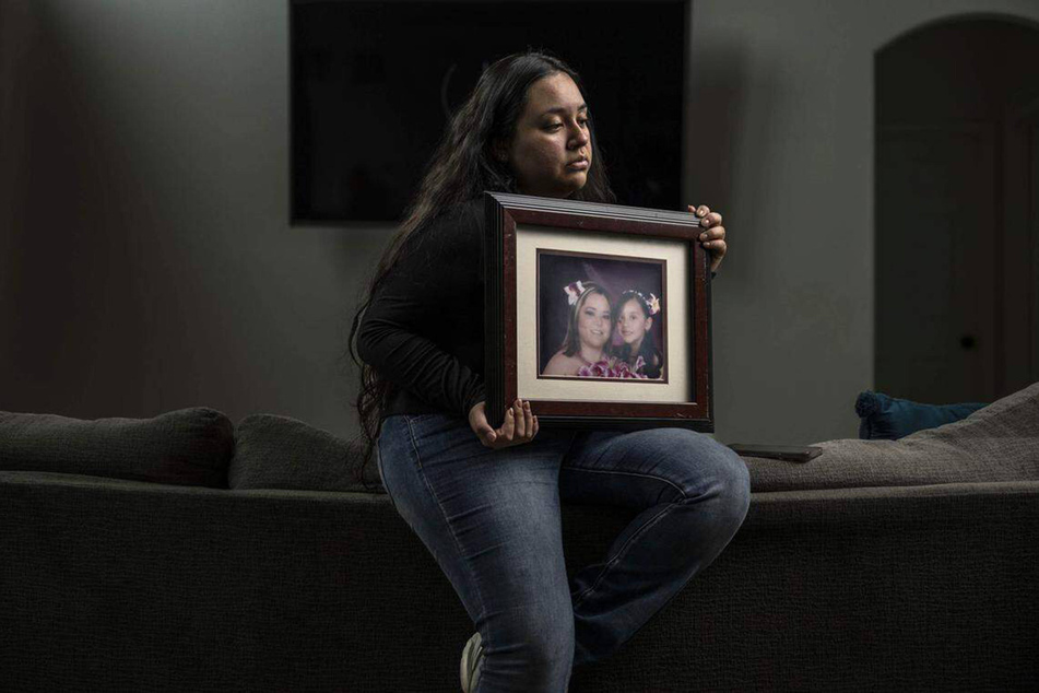Damaris Bello holds a picture of herself with her mother, Maria de Jesus Estrada Juarez, on February 23, 2026.