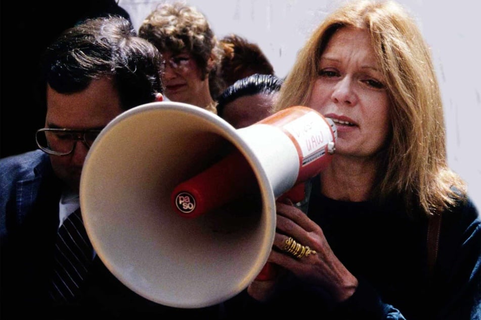 Gloria Steinem is pictured speaking into a megaphone in New York City in 1988.