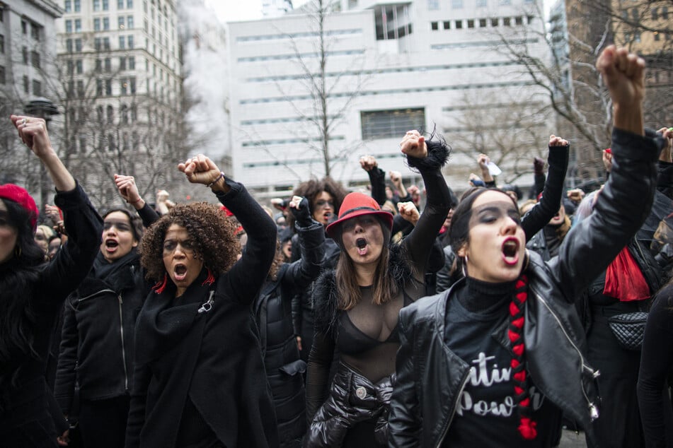 Women protest against rape as they sing a song in front of the court while Harvey Weinstein attends a pretrial session on January 10, 2020 in New York City.