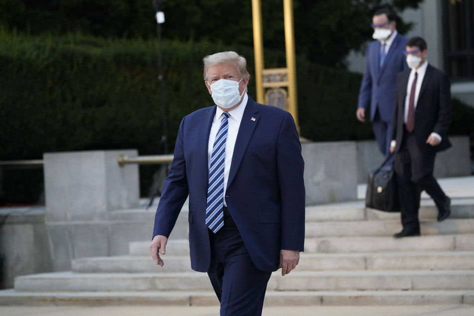 Donald Trump briefly leaves hospital to greet supporters despite Covid illness
