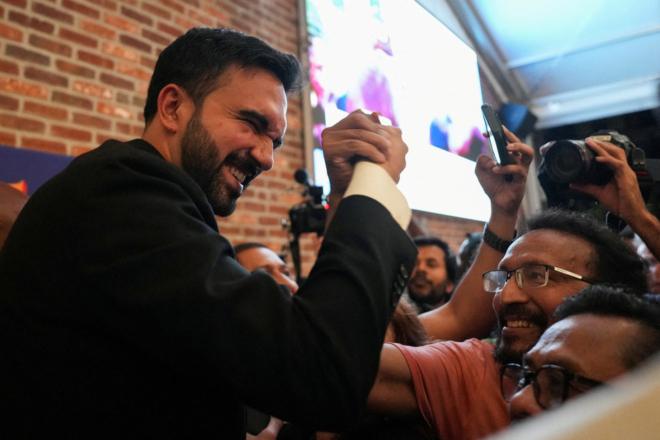 Zohran Mamdani (l.) greets a supporter during a watch party for his New York City Democratic mayoral primary election on June 25, 2025.