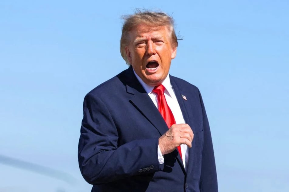 President Donald Trump speaks to reporters as he walks to board Air Force One on October 23, 2026 at Joint Base Andrews, Maryland. On Friday, President Donald Trump's administration lifted tariffs on some Canadian imports to help a Senate candidate in a key midterm race.