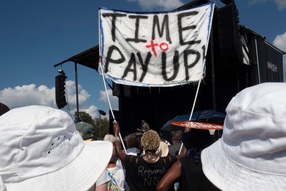 A participant in the 60th anniversary of the March on Washington on August 26, 2023, calls for reparations.