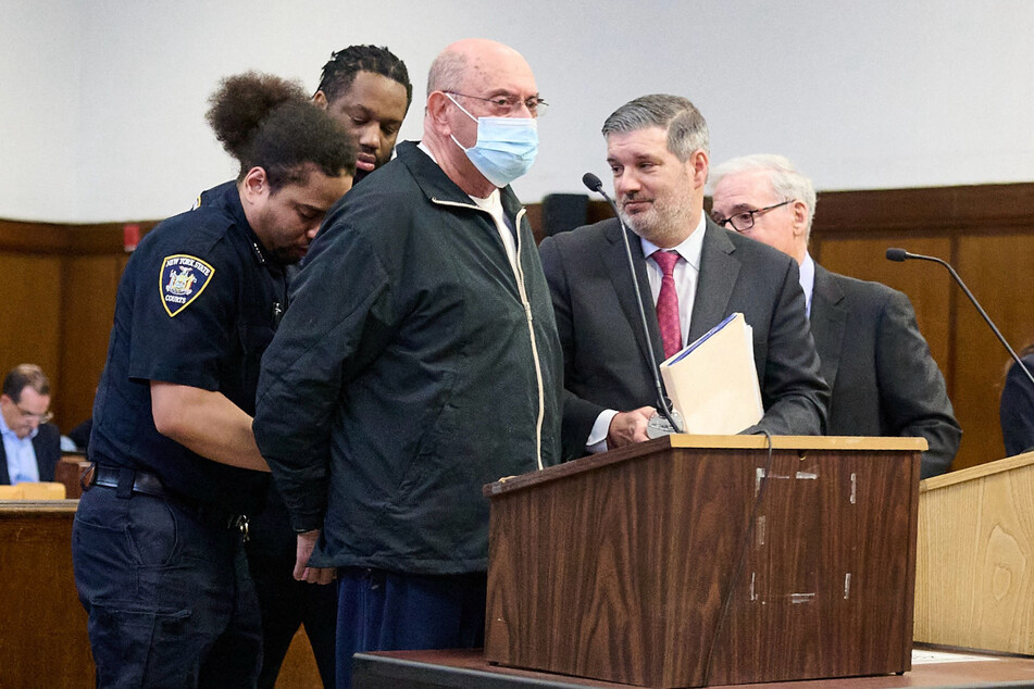 Former Trump Organization Chief Financial Officer Allen Weisselberg (c.) is handcuffed after being sentenced at Manhattan Criminal Court on Wednesday in New York City.