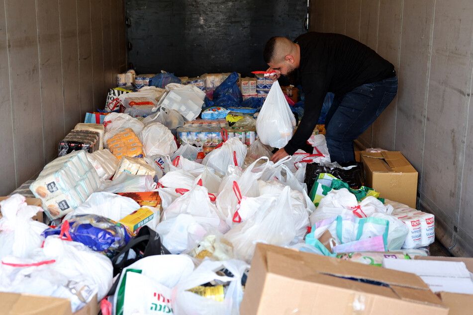 Activists from the Standing Together movement fill a truck with food aid in the southern Israeli city of Ashkelon on Thursday in a symbolic show of support for Palestinians.