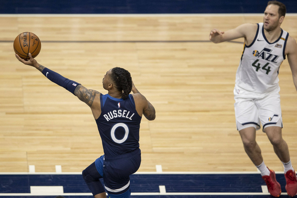 D Angelo Russell scores past Bojan Bogdanovic of the Jazz as the T'Wolves won 105-104 on Monday night