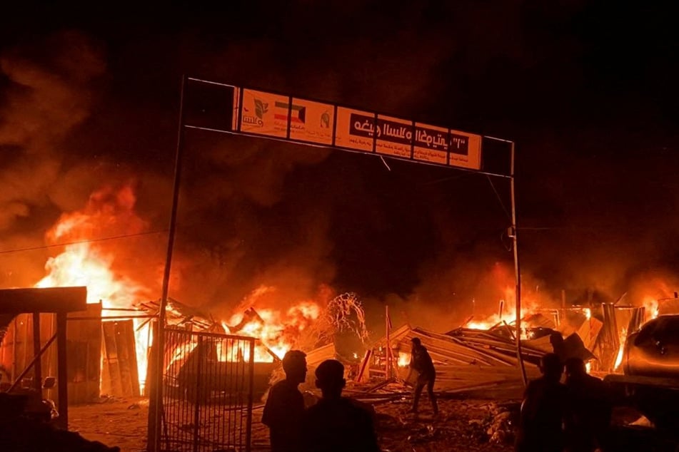Fire rages following an Israeli strike on an area designated for displaced Palestinians in Rafah in the southern Gaza Strip.