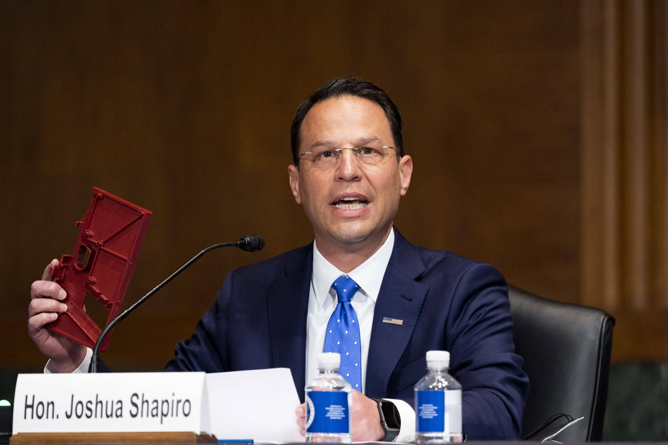 Pennsylvania Attorney General Josh Shapiro holds up a Polymer80 ghost gun frame kit during a 2018 Senate Committee on the Judiciary hearing.