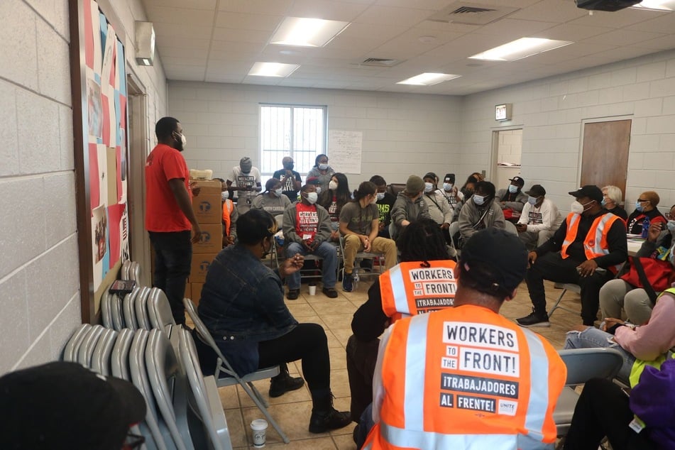 Aaron Womack leads the Columbus team in a morning launch ahead of a day of canvassing for the Georgia Senate runoff.