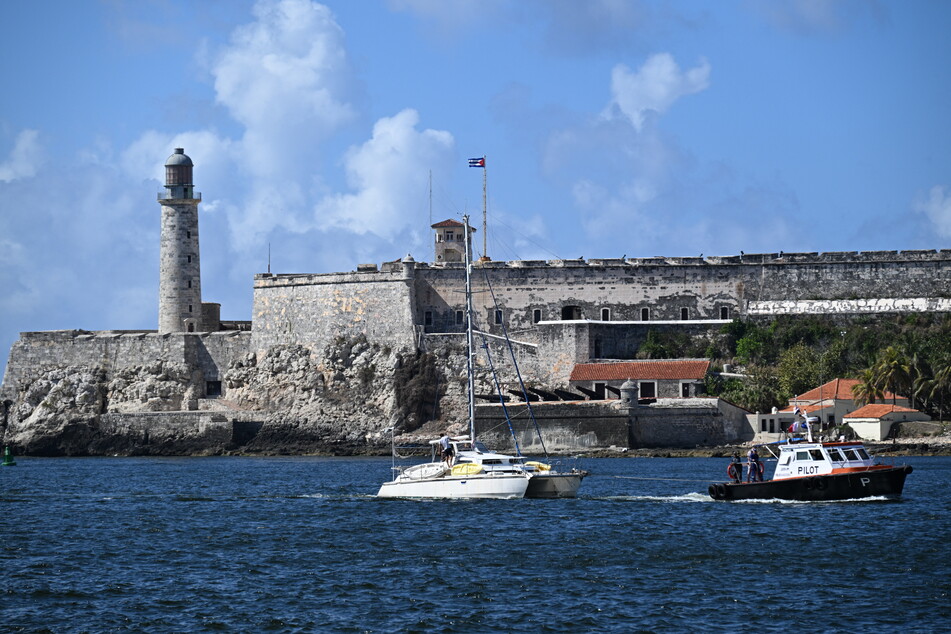 This view shows one of the two sailboats (L) carrying humanitarian aid that had previously gone missing arriving at the port of Havana on Saturday.