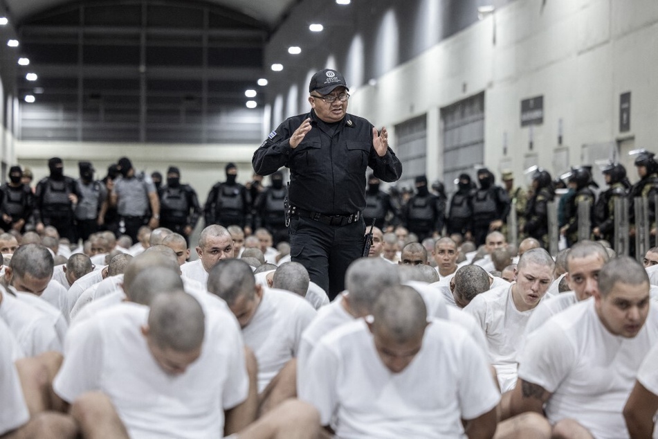 This handout picture released on March 16, 2025, by El Salvador's Presidency press office shows the arrival of alleged members of the Venezuelan criminal organization Tren de Aragua at the Terrorism Confinement Center in the city of Tecoluca.
