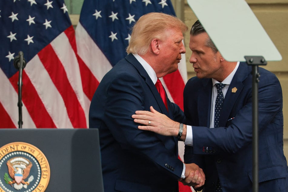 President Donald Trump (l) shakes hands with Secretary of Defense Pete Hegseth (r) during a ceremony commemorating the 25th anniversary of 9/11. They both agreed on execution by firing squad for Nidal Hasan.