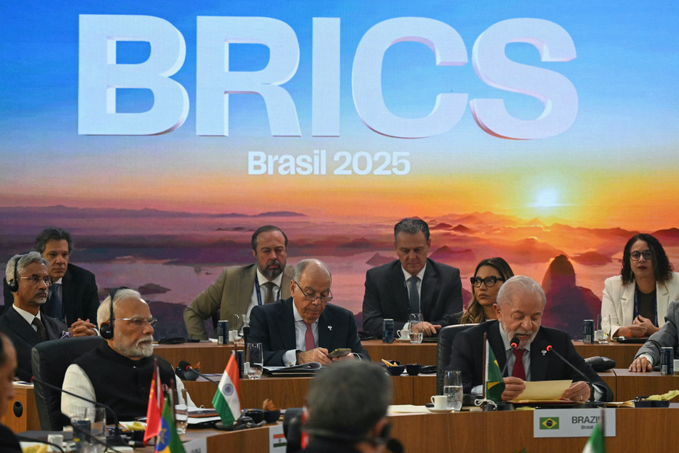 Brazil's President Luiz Inacio Lula da Silva (R) speaks next to India's Prime Minister Narendra Modi (L) during the first plenary session of the BRICS summit in Rio de Janeiro, Brazil, on Sunday.