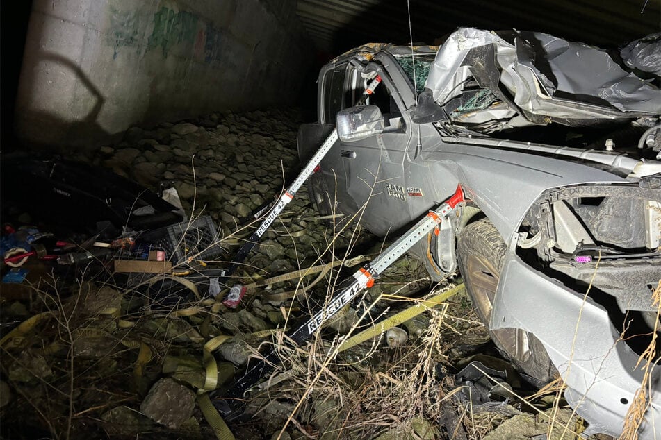 The man, reported to be Matthew Reum, was found alive in his destroyed truck, which had crashed and rolled off an Indiana highway.