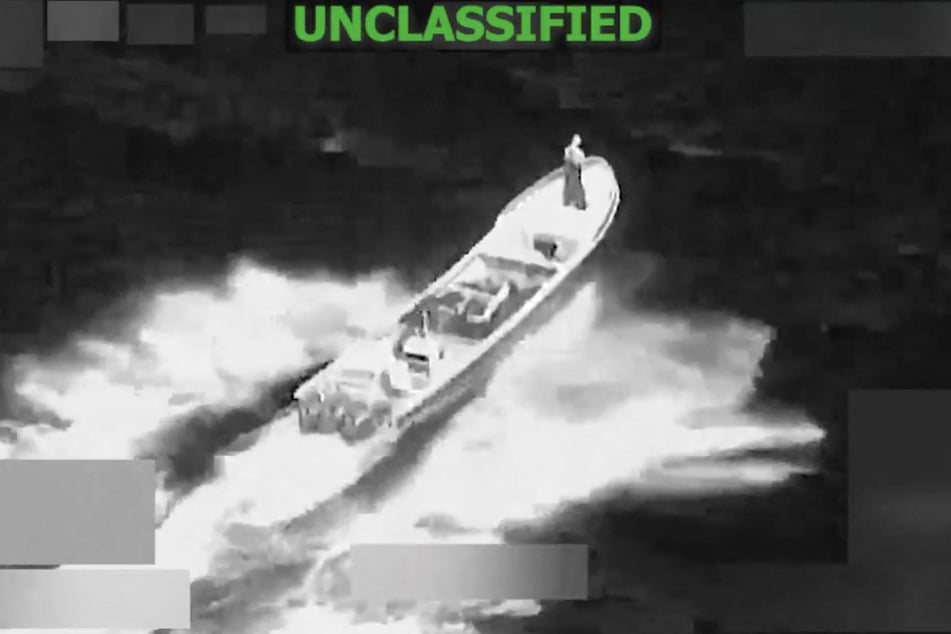 A screen grab from a video posted on the X account of US Southern Command on January 23, 2026, shows a strike on a vessel in international waters.