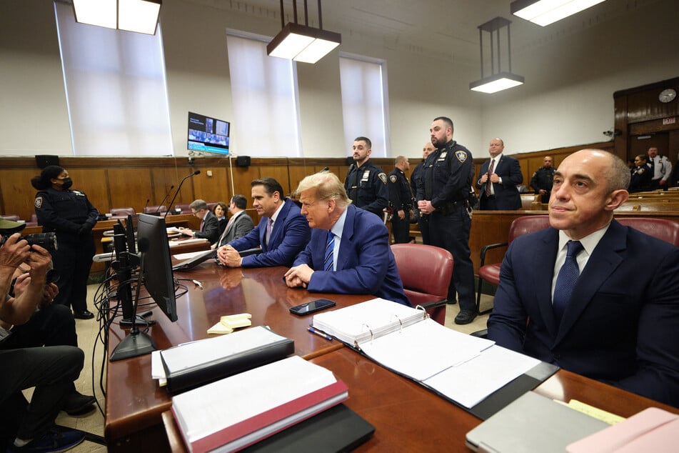 Former US President Donald Trump (c.) attends jury selection on the second day of his trial for allegedly covering up hush money payments at Manhattan Criminal Court on Tuesday in New York City.