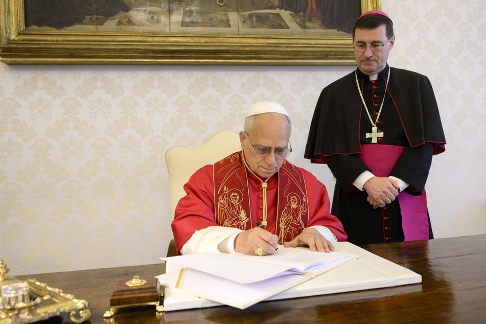 Pope Leo XIV signs his first Encyclical Letter "Magnifica Humanitas," focused on the rise of artificial intelligence, at the Vatican on May 15, 2026.