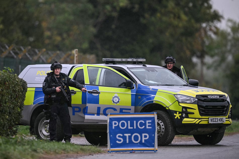 Armed police man a roadblock while posted outside RAF Fairford base on September 27. The airbase has also been used by the US military in its war against Iran.