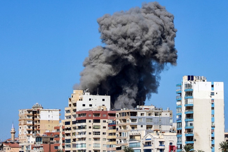 A large smoke plume rises following an Israeli air strike on a neighborhood of Lebanon's southern city of Tyre on October 23, 2024.