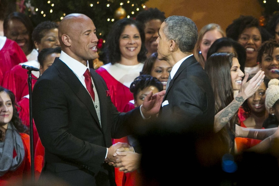 Dwayne "The Rock" Johnson shakes hands with former President Barack Obama.