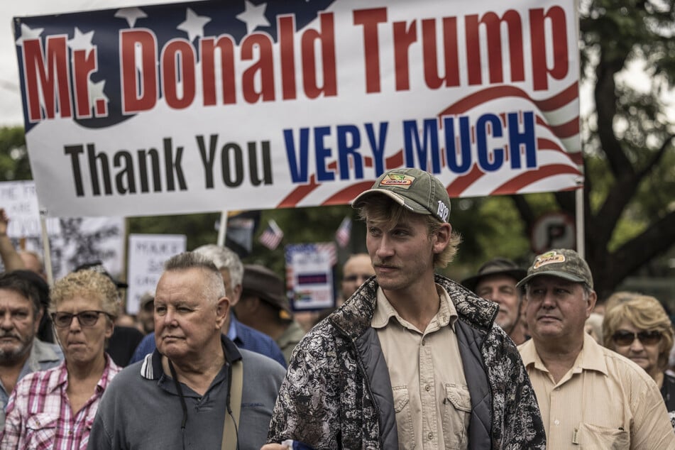 White South Africans supporting Donald Trump and Elon Musk gather in front of the US Embassy in Pretoria on February 15, 2025, for a demonstration.