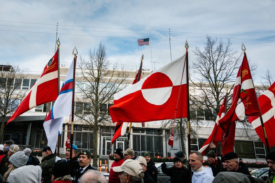 A Greenland flag flies as Danish veterans attend a "silent manifestation march" from Kastellet to the US embassy in Copenhagen to express dissatisfaction with President Donald Trump's statements about NATO soldiers in Afghanistan on January 31, 2026.