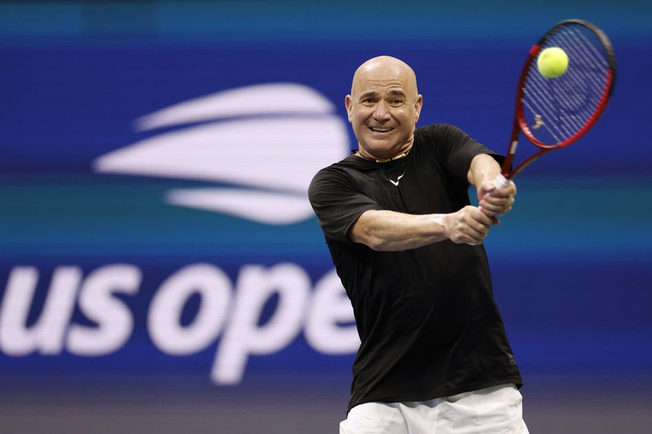 Andre Agassi in action during his US Open doubles exhibition match with Andy Roddick (not pictured) on August 25, 2026. Agassi has said he does not support slashing sets in Grand Slam matches.