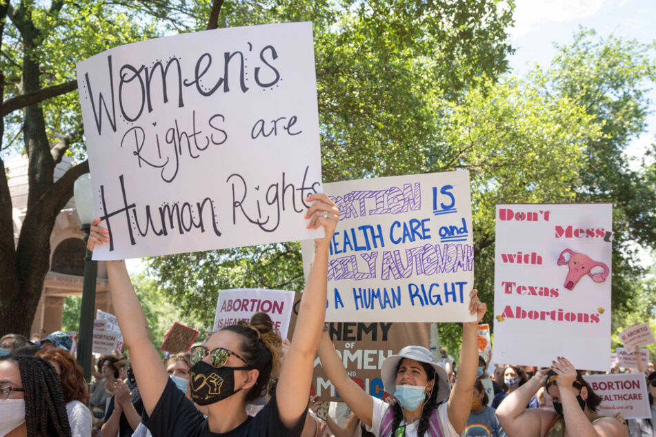 Women rally at the Texas State Capitol in protest of an abortion ban that was signed into law by Governor Greg Abbott.