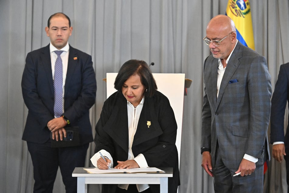 Venezuela opposition representative Dinorah Figuera signs a joint agreement following the first round of post-Maduro talks.