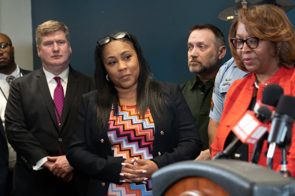 Fulton County District Attorney Fani Willis (c.) has been building the state's case against Donald Trump for two-and-a-half years.
