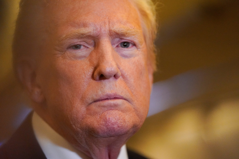 President Donald Trump speaks to members of the media as he flies to Washington aboard Air Force One on October 19, 2025.