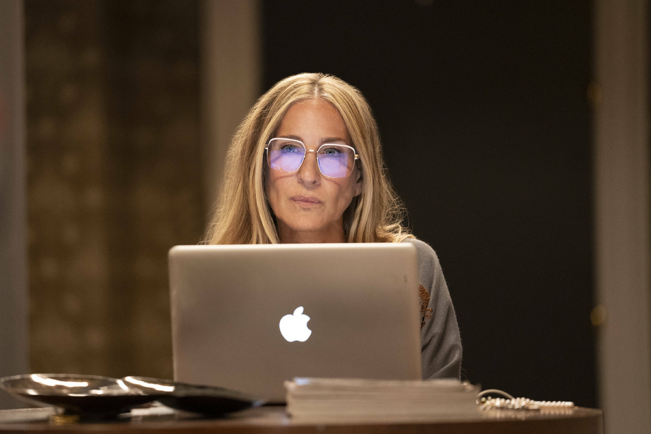 Sarah Jessica Parker's character, Carrie Bradshaw, continues to struggle with the loss of her husband and her past mistakes in And Just Like That..